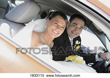 Stock Photography - Bride and groom in the car. Fotosearch