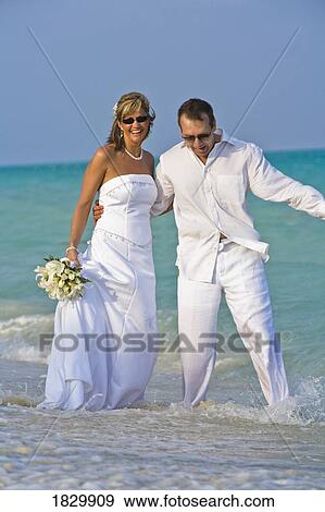 Bride and groom on beach View Large Photo Image Stock Photo - Bride and groom on beach. Fotosearch
