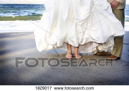 Stock Photo - Bride and groom on the beach. Fotosearch
