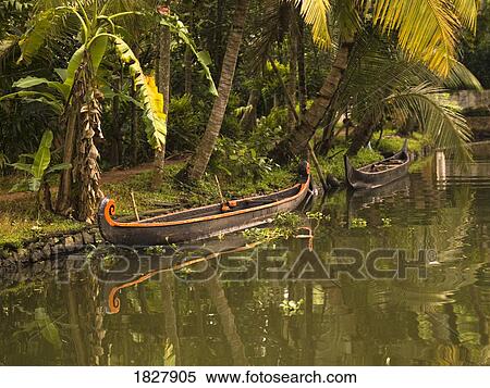 Stock Photography - Canoe in the water, India . Fotosearch