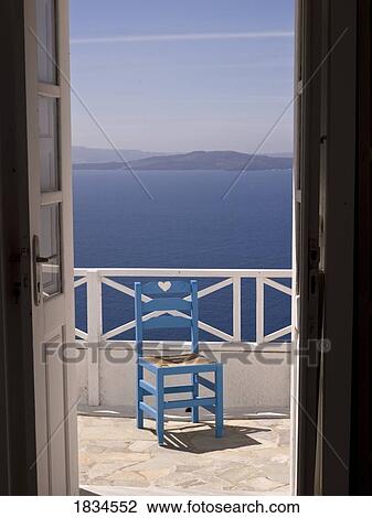 Stock Image - Chair on patio, Santorini, Greece . Fotosearch