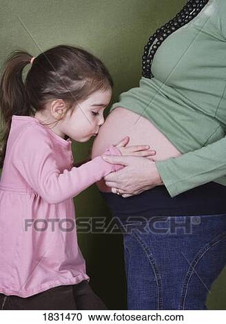 Child kissing mother's pregnant belly View Large Photo Image Stock Image - Child kissing mother's pregnant belly. Fotosearch