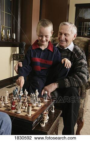 Child playing chess with Grandfather View Large Photo Image Stock Image - Child playing chess with Grandfather. Fotosearch