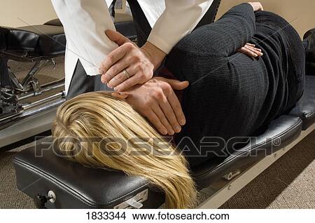 Chiropractor with his patient View Large Photo Image Picture - Chiropractor with his patient. Fotosearch