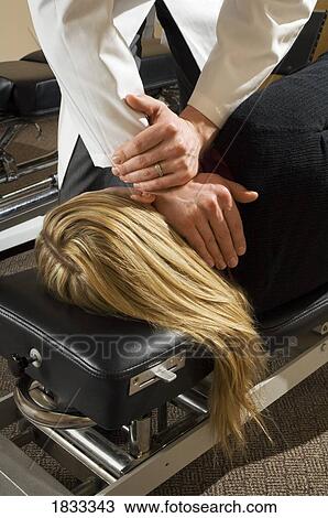 Stock Image - Chiropractor with his patient. Fotosearch