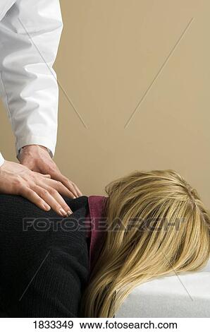 Stock Photo - Chiropractor with his patient. Fotosearch