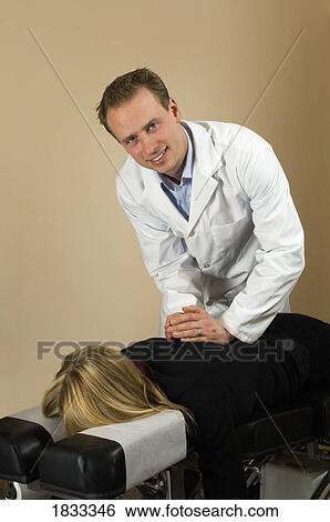 Stock Photograph - Chiropractor with his patient. Fotosearch