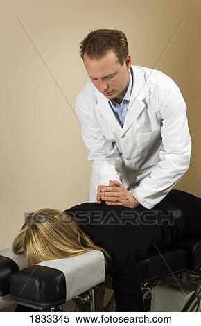 Chiropractor with his patient View Large Photo Image Stock Photography - Chiropractor with his patient. Fotosearch