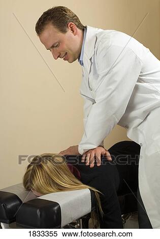 Stock Photography - Chiropractor with his patient. Fotosearch