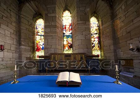 Stock Image - Church and open Bible, Holy Island, Bewick, England. Fotosearch