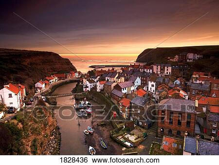 Stock Photograph - Cityscape at sunset, Staithes, Yorkshire, England. Fotosearch