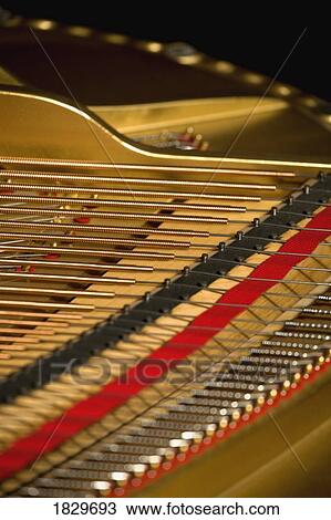 Stock Image - Close up of piano strings. Fotosearch