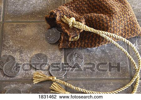 Stock Image - Cloth bag and silver coins. Fotosearch