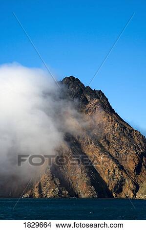 Cloud covering a mountain, Greenland View Large Photo Image Picture - Cloud covering a mountain, Greenland. Fotosearch