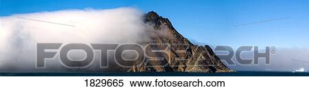 Cloud covering a mountain, Greenland View Large Photo Image Stock Photography - Cloud covering a mountain, Greenland. Fotosearch