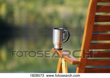 Coffee mug on deck chair View Large Photo Image Stock Image - Coffee mug on deck chair. Fotosearch
