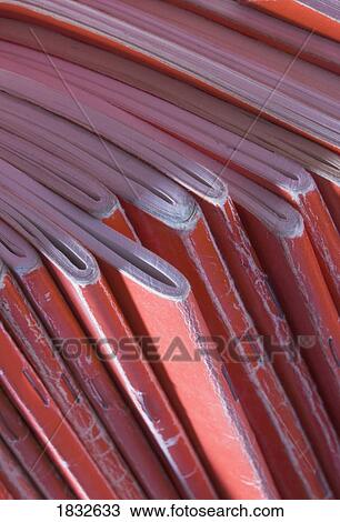 Stock Image - Collection of well used red notebooks . Fotosearch