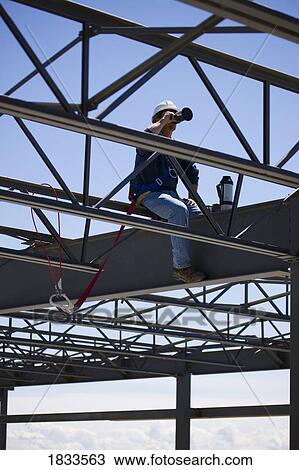 Stock Image - Construction worker during break. Fotosearch