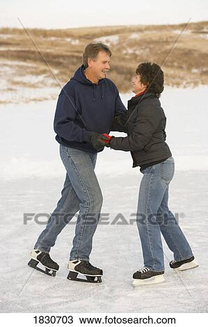 Couple ice skating together View Large Photo Image Stock Image - Couple ice skating together. Fotosearch