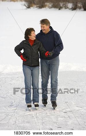 Couple ice skating together View Large Photo Image Stock Photography - Couple ice skating together. Fotosearch