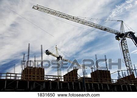Cranes at work View Large Photo Image Stock Image - Cranes at work. Fotosearch