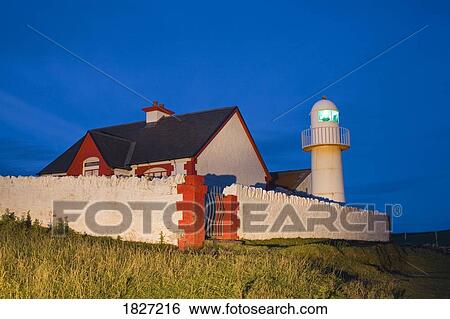 Stock Photograph - Dingle, Dingle Peninsula, County Kerry, Ireland; Lighthouse at dusk . Fotosearch