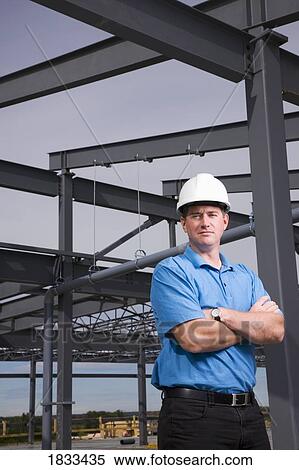 Engineer leaning against metal beam View Large Photo Image Stock Photography - Engineer leaning against metal beam. Fotosearch