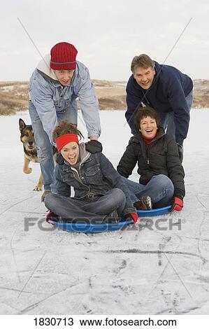 Stock Image - Family enjoying the winter. Fotosearch