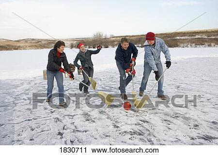 Family playing broomball View Large Photo Image Stock Image - Family playing broomball. Fotosearch