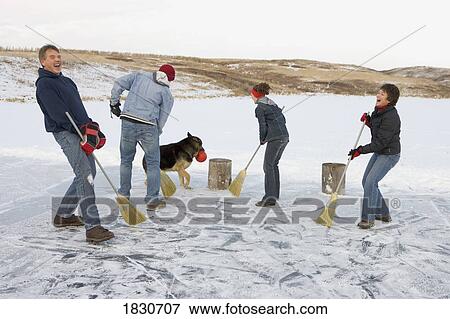 Family playing broomball View Large Photo Image Stock Photo - Family playing broomball. Fotosearch