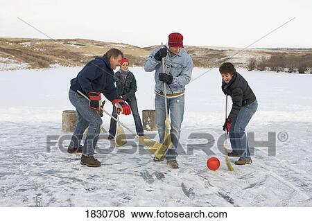 Family playing broomball View Large Photo Image Stock Photo - Family playing broomball. Fotosearch