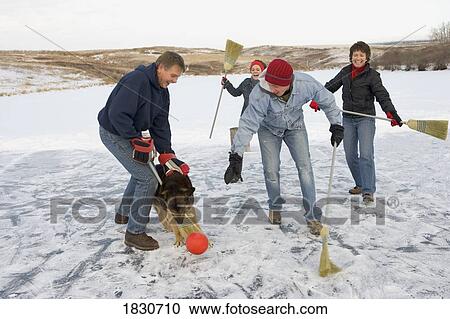Family playing broomball with their dog View Large Photo Image Stock Image - Family playing broomball with their dog. Fotosearch