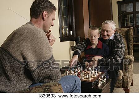 Stock Image - Family playing Chess. Fotosearch
