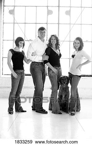 Stock Photo - Family with two daughters and a dog. Fotosearch
