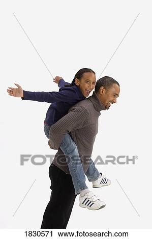 Stock Image - Father giving daughter a piggy back ride. Fotosearch