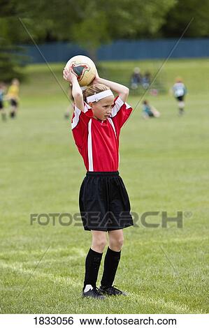 Stock Photograph - Female soccer player throwing the ball . Fotosearch