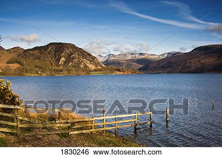 Stock Photograph - Fence on lake shore at Lake District, Cumbria, England. Fotosearch