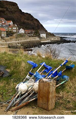 Stock Photograph - Fishing supplies on the water's edge. Fotosearch