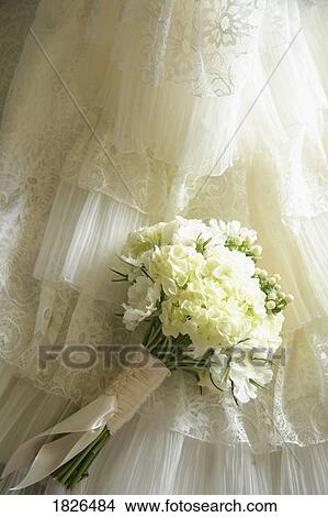 Flower bouquet against wedding dress View Large Photo Image Picture - Flower bouquet against wedding dress. Fotosearch