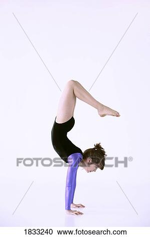 Stock Image - Girl doing handstand. Fotosearch