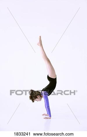 Stock Image - Girl doing handstand. Fotosearch