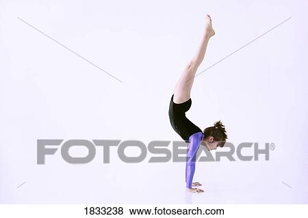 Stock Photo - Girl doing handstand. Fotosearch
