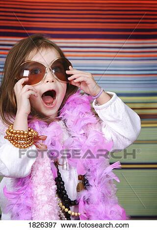 Girl dressing up View Large Photo Image Stock Photo - Girl dressing up. Fotosearch