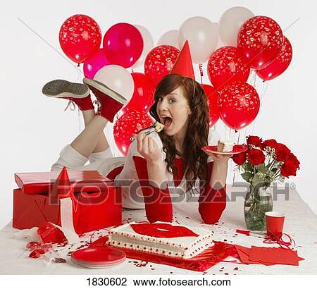 Stock Image - Girl eating cake with balloons. Fotosearch