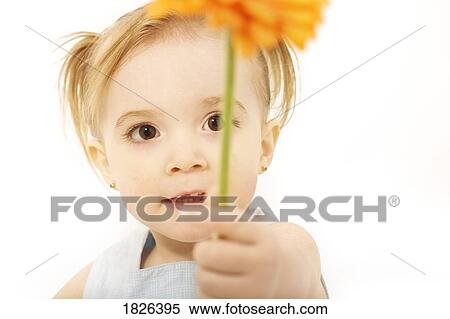 Stock Photography - Girl holding a flower. Fotosearch