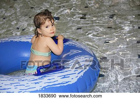 Stock Image - Girl in inner tube. Fotosearch