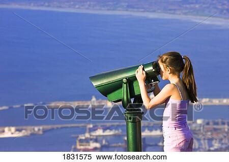 Stock Photography - Girl looking through binoculars at Cape Town, Table Mountain, South Africa, Africa . Fotosearch