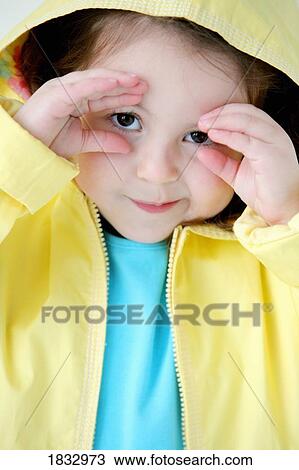 Girl peeking out of raincoat View Large Photo Image Stock Image - Girl peeking out of raincoat. Fotosearch