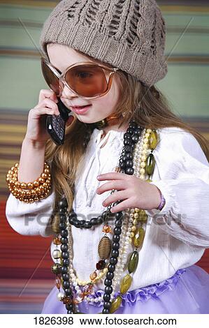 Stock Photo - Girl playing dress up. Fotosearch