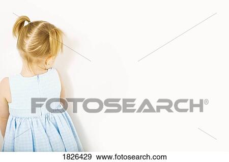 Stock Photo - Girl standing in the corner. Fotosearch